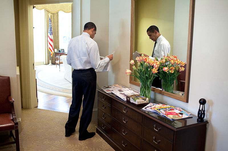 President Barack Obama reads the newspaper in the White House's Outer Oval Office in this March 2009 file photo by Maison Blanche. Courtesy of Wikimedia Commons